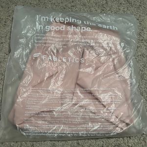 Light pink Fabletics shorts. Stretchy w/phone pocket. Size M. Brand NEW.